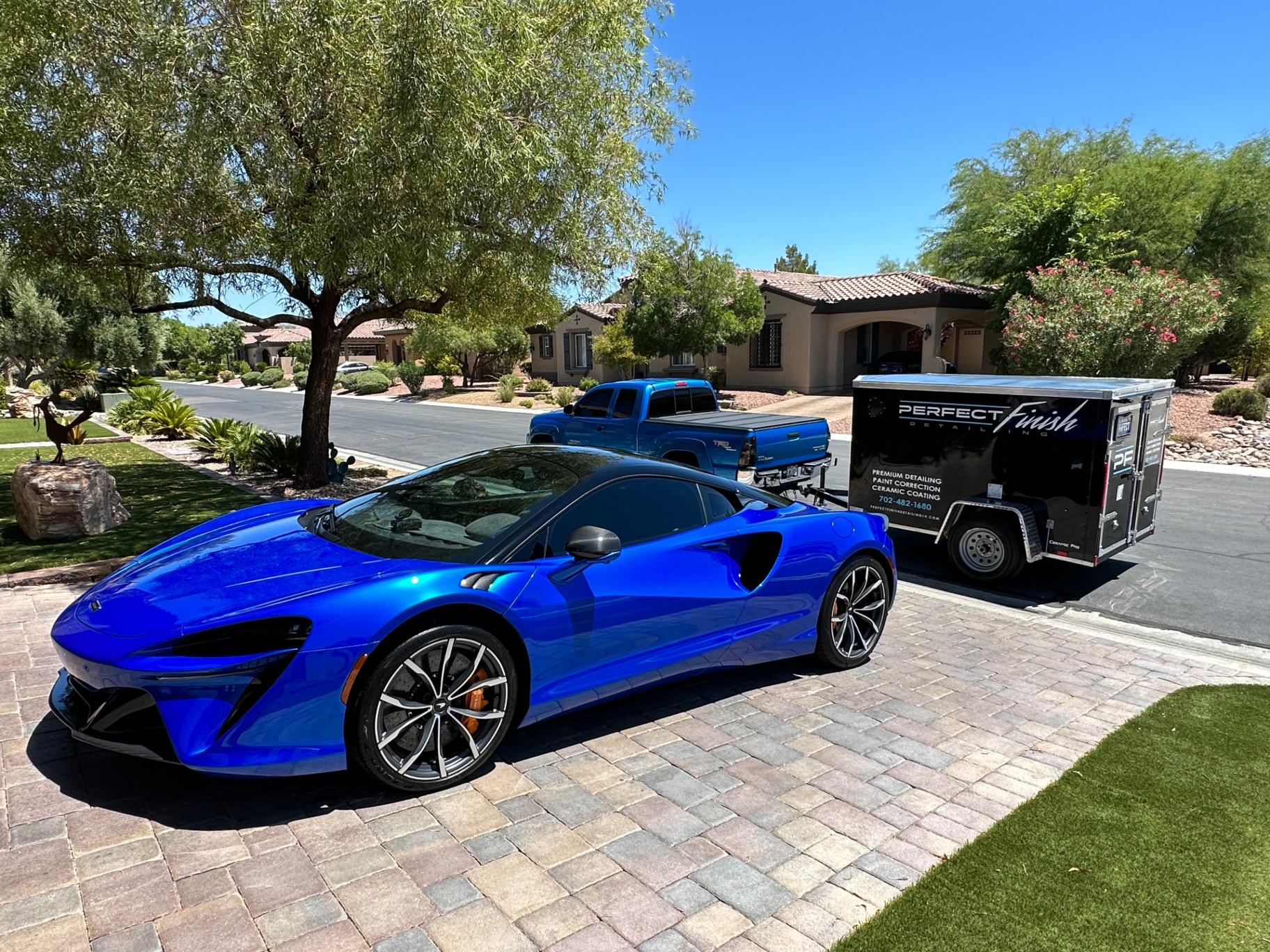 Perfect Finish mobile detailing trailer parked beside a blue McLaren in Las Vegas